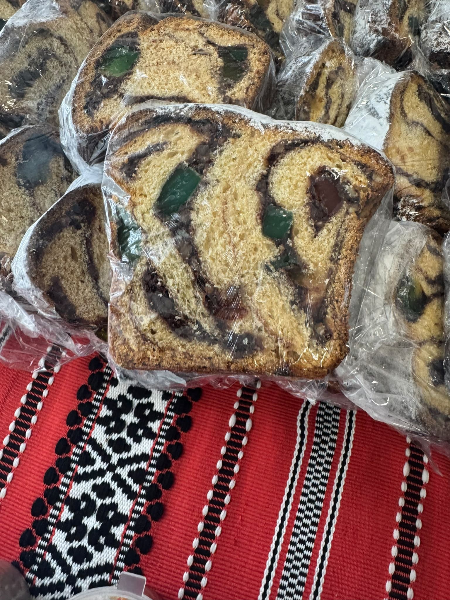 Individually wrapped slices of homemade cozonac on a traditional cloth